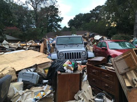 Vehicle surrounded by household goods